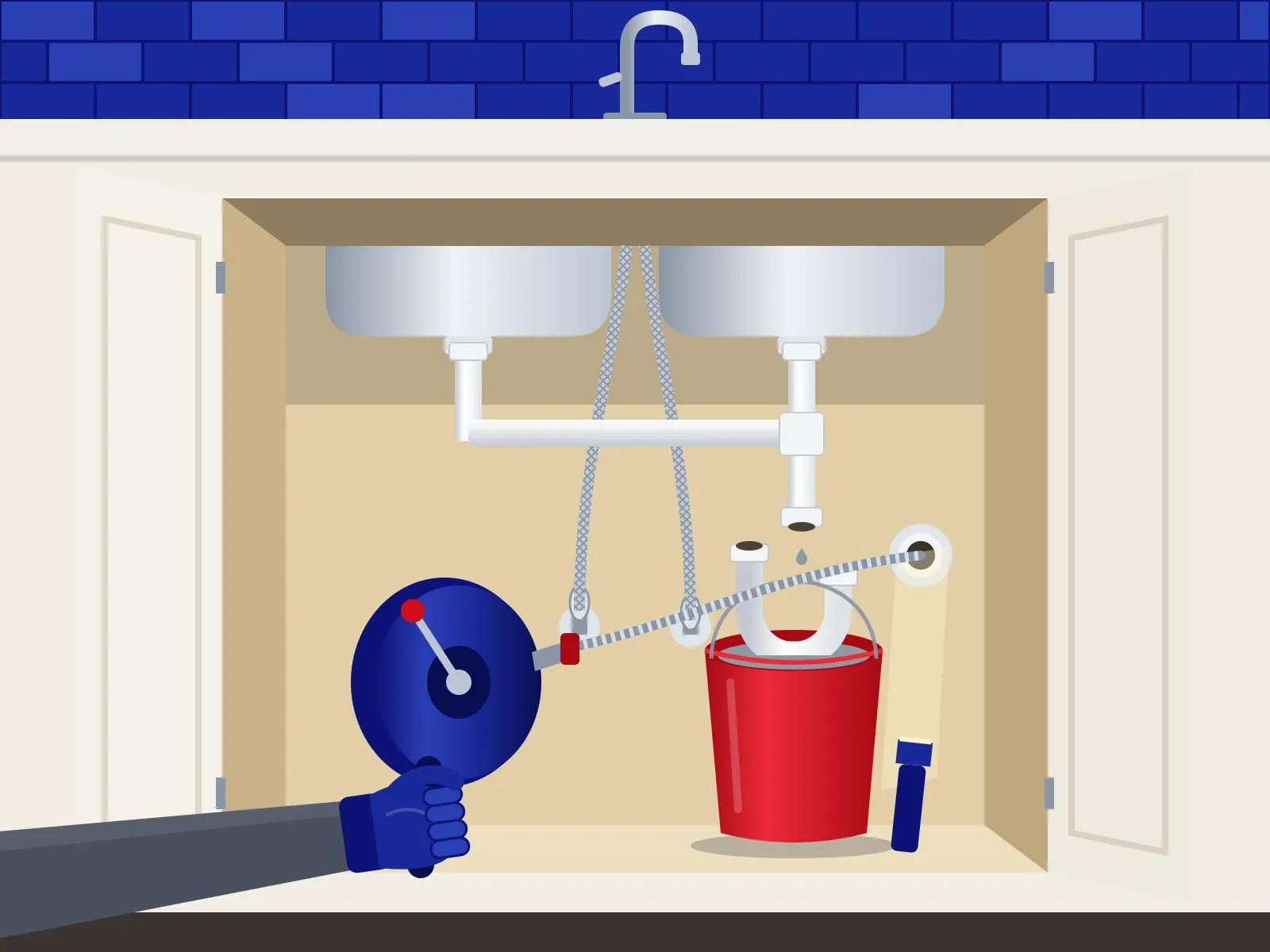 Illustration of a gloved hand running a drum auger into a kitchen sink drain, the removed trap sitting in a red bucket